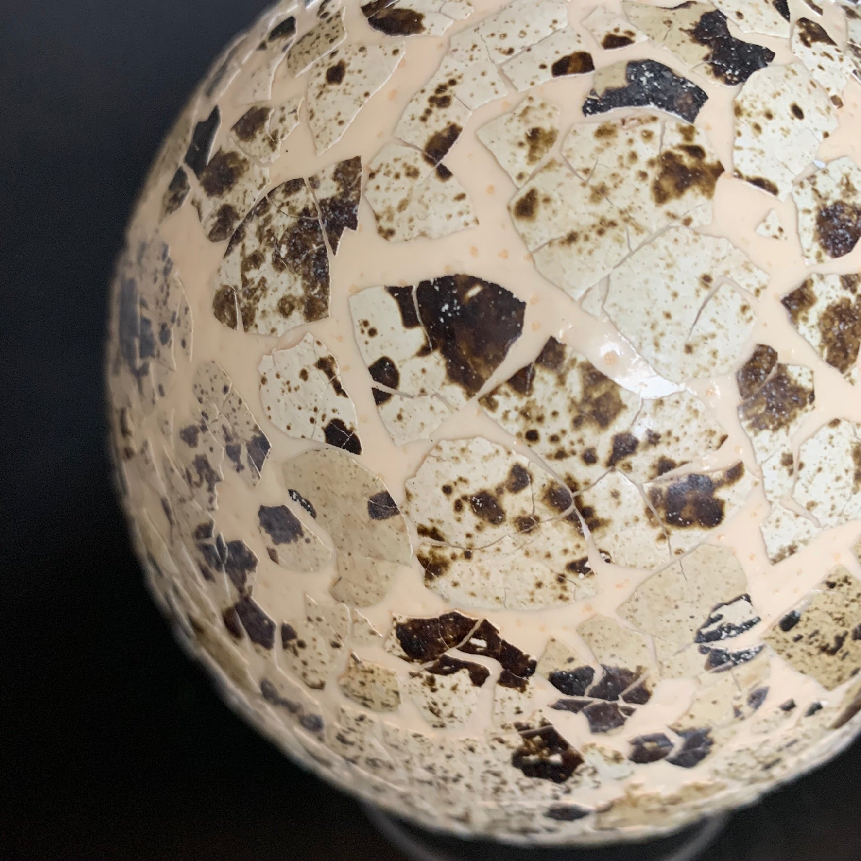 Ostrich egg decorated all around with quail egg shells